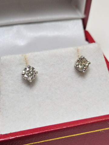 14K white gold stud earrings with 0.66ct round diamonds, featuring a sleek design and elegant sparkle from Chique Jewelry.