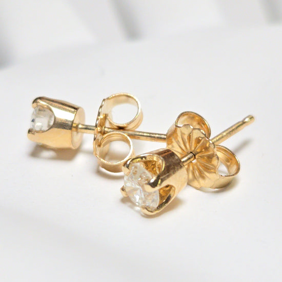 14K gold stud earrings featuring 0.48ct round diamonds, from Chique Jewelry, showcasing elegant jewelry design.