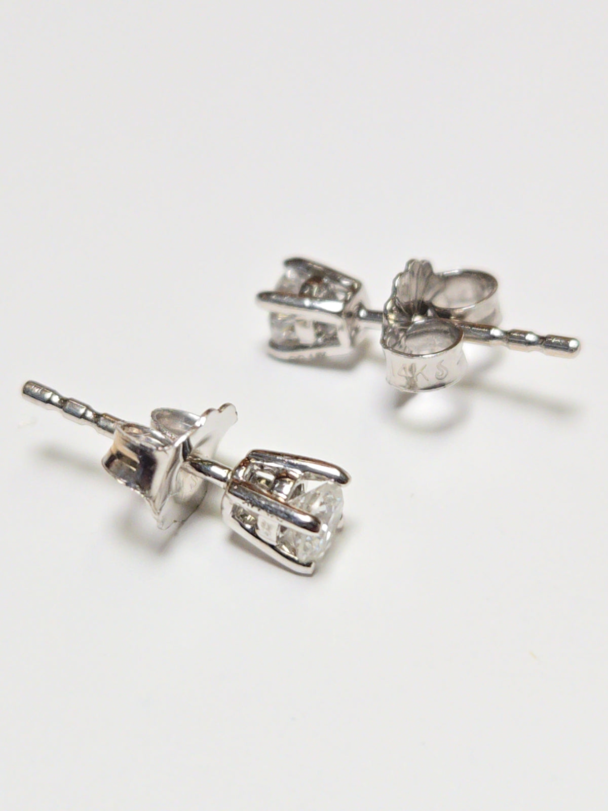 14K white gold stud earrings with 0.24ct round lab-created diamonds, featuring a sleek design and sparkling brilliance.