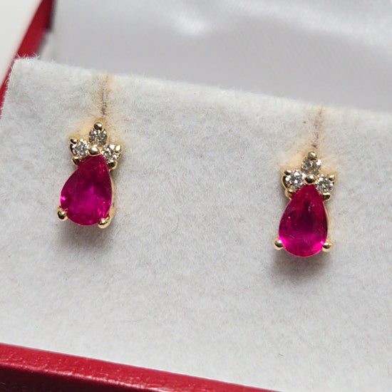 14K gold stud earrings featuring a 0.9ct pear-shaped ruby, crafted by Chique Jewelry, displayed on a clean background.