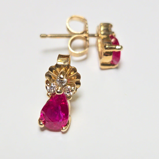 14K gold stud earrings featuring 0.9ct pear-shaped ruby gemstones, crafted by Chique Jewelry.