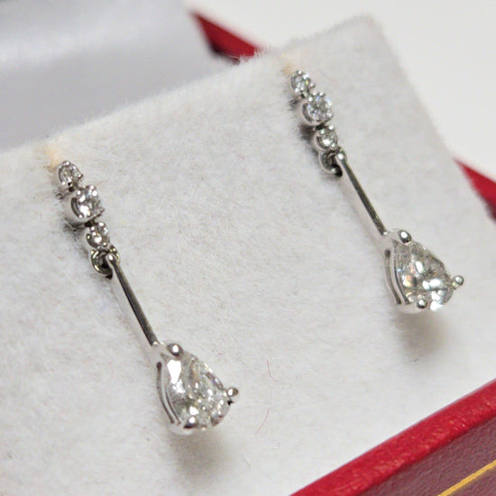 14K white gold drop earrings with 0.38ct pear-shaped diamond and delicate design by Chique Jewelry.