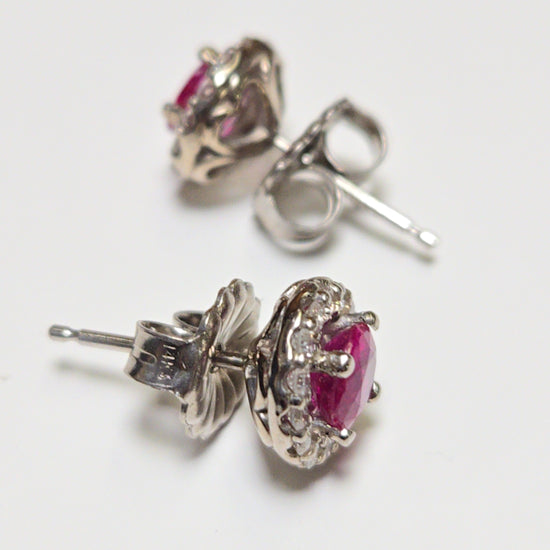 14K white gold two-stone stud earrings with 0.97ct round rubies from Chique Jewelry, featuring a sleek, elegant design.