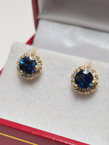 14K gold two-stone stud earrings featuring 1.3ct round blue sapphires by Chique Jewelry, with a sleek, polished finish.