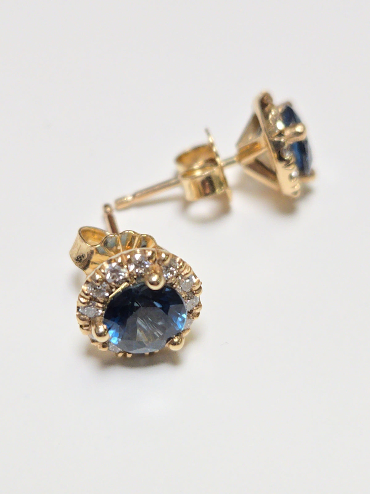 14K gold two-stone stud earrings featuring 1.3ct round blue sapphires, from Chique Jewelry, with a sleek, elegant design.