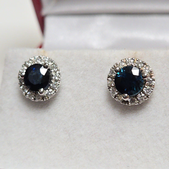 14K white gold two-stone stud earrings with 1.56ct round blue sapphires, from Chique Jewelry, featuring elegant gemstone setting.