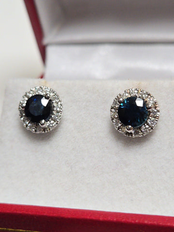 14K white gold two-stone stud earrings with 1.56ct round blue sapphires, from Chique Jewelry, featuring elegant gemstone setting.