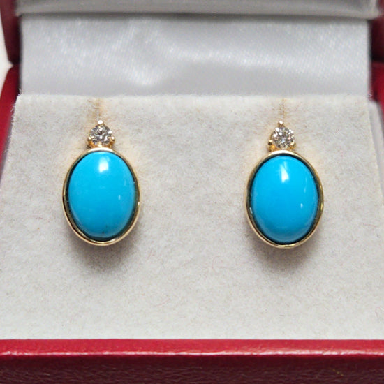 14K gold stud earrings with oval Sleeping Beauty turquoise gemstones from Chique Jewelry, weighing 2.3 grams.