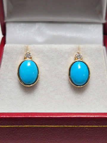14K gold stud earrings with oval Sleeping Beauty turquoise gemstones from Chique Jewelry, weighing 2.3 grams.