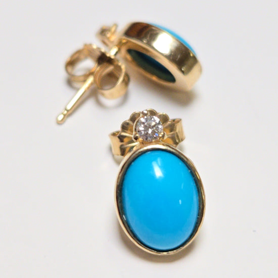 14K gold stud earrings featuring oval Sleeping Beauty turquoise stones, crafted by Chique Jewelry.