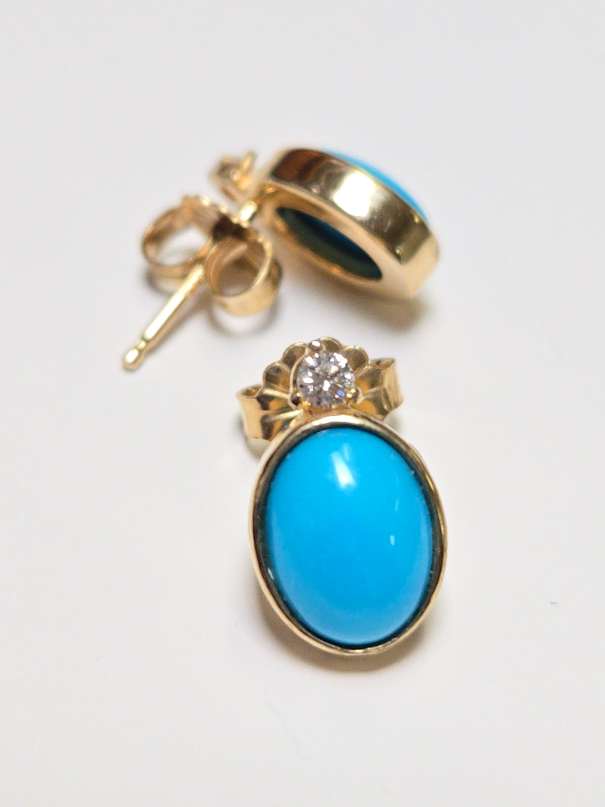 14K gold stud earrings featuring oval Sleeping Beauty turquoise stones, crafted by Chique Jewelry.
