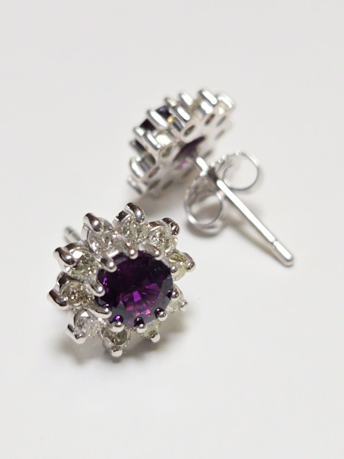 14K white gold two-stone stud earrings featuring 1.7ct round red sapphires, from Chique Jewelry, with a sleek and elegant design.