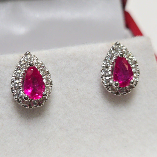 14K white gold two-stone stud earrings featuring 1.02ct pear-shaped ruby gemstones by Chique Jewelry.