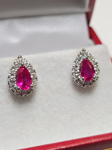 14K white gold two-stone stud earrings featuring 1.02ct pear-shaped ruby gemstones by Chique Jewelry.