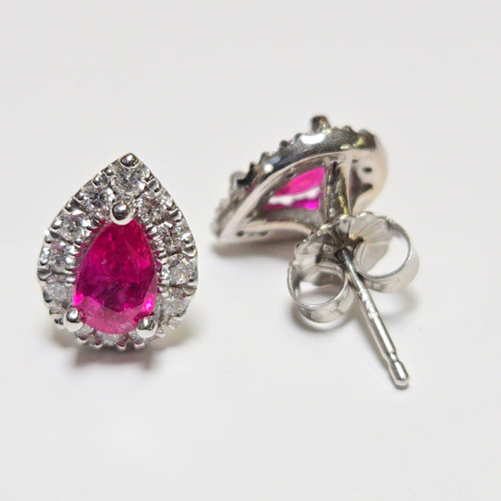 14K white gold two-stone stud earrings featuring 1.02ct pear-shaped ruby gemstones, from Chique Jewelry.
