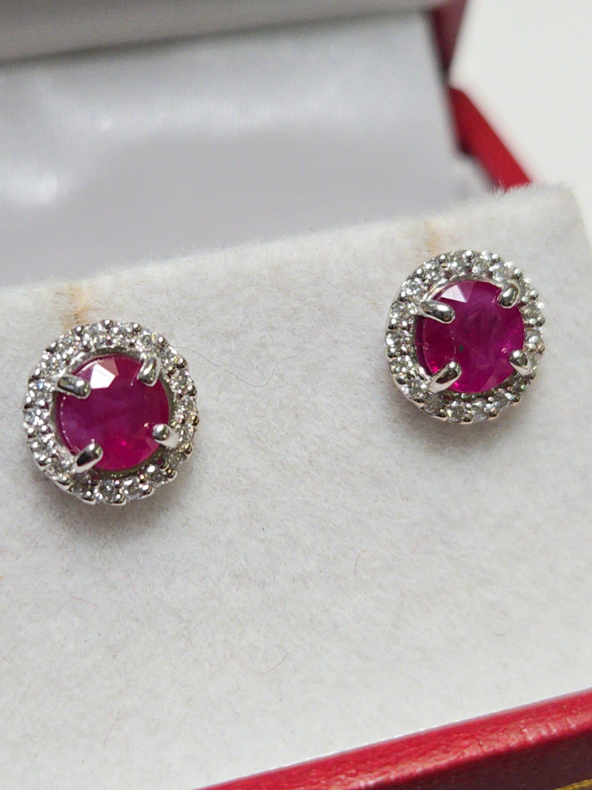 14K white gold two stone stud earrings with 1.3ct round rubies from Chique Jewelry, featuring a simple, elegant design.