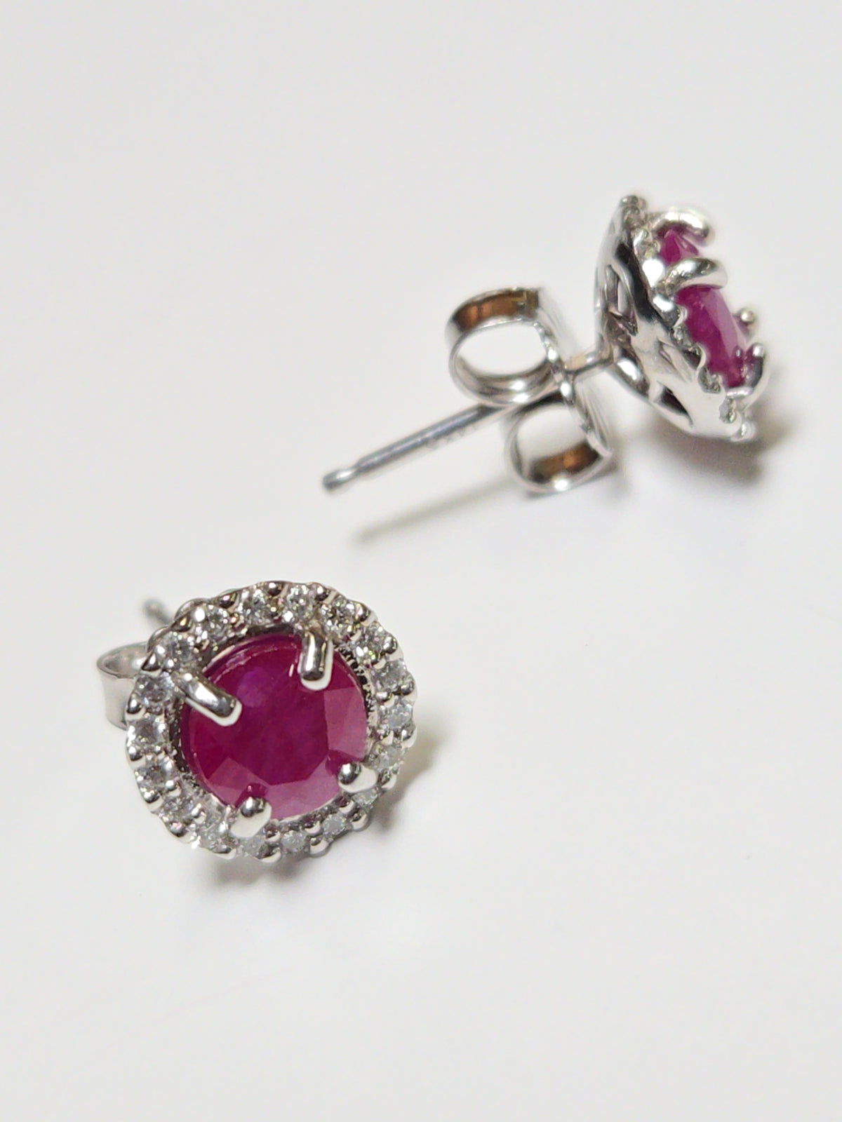 14K white gold two-stone stud earrings featuring 1.3ct round rubies from Chique Jewelry, sparkling and elegant.