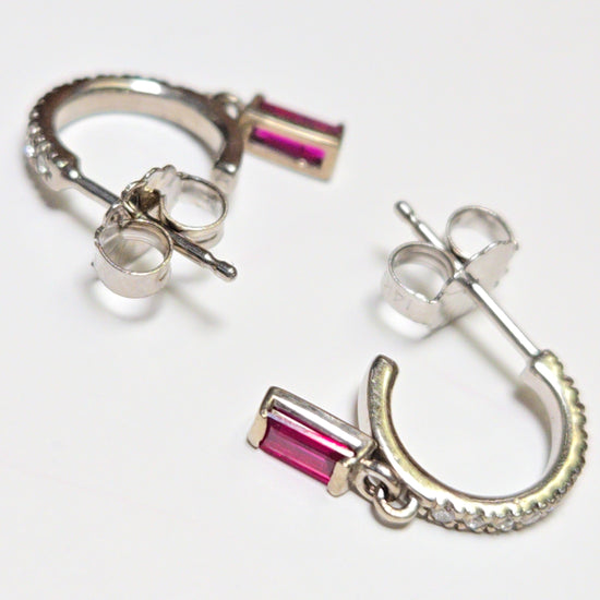 14K white gold hoop earrings with 0.24ct emerald-cut ruby accents, crafted by Chique Jewelry.