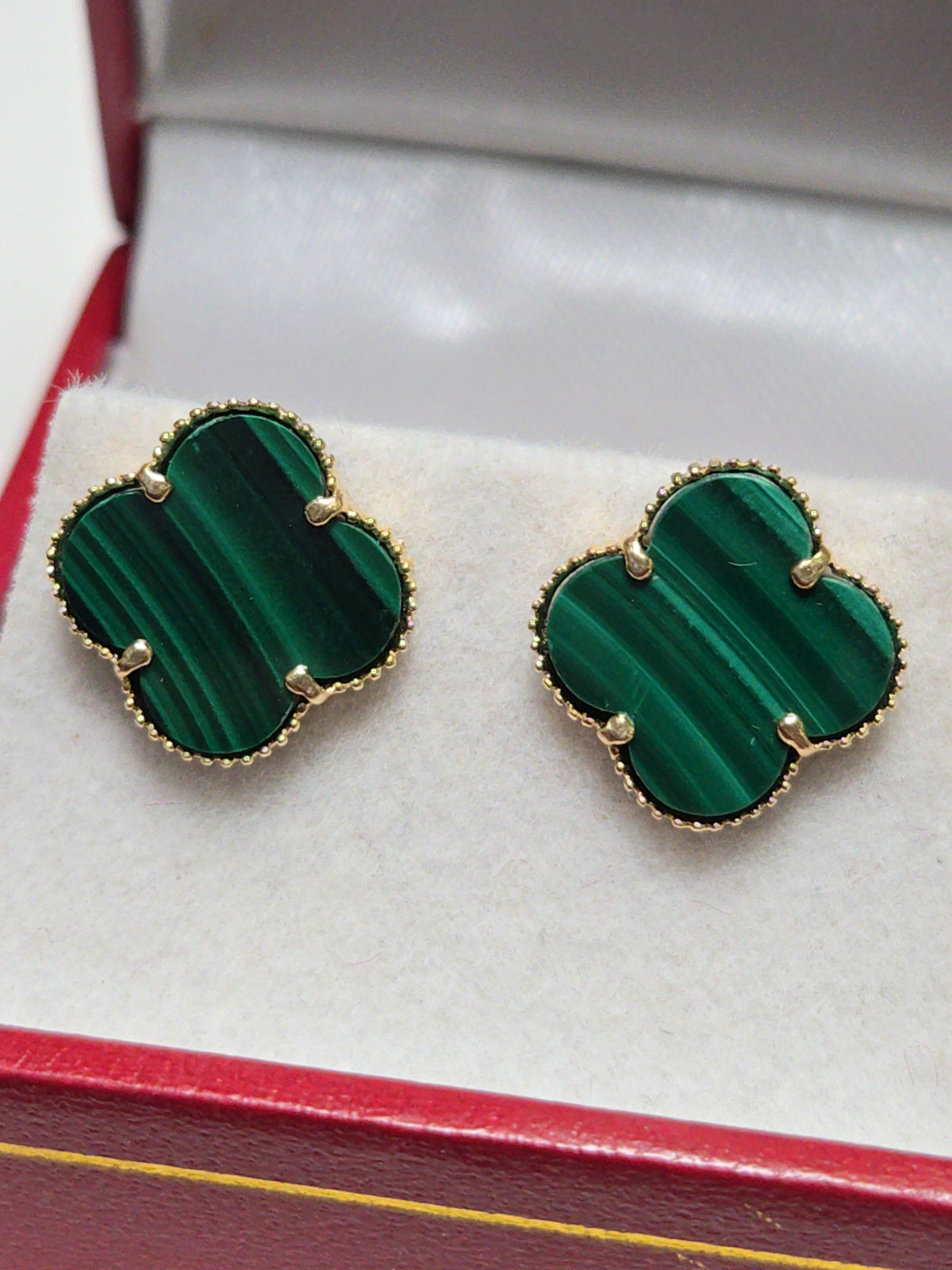 14K gold stud earrings featuring green malachite in a clover shape, weighing 2.5 grams, from Chique Jewelry.