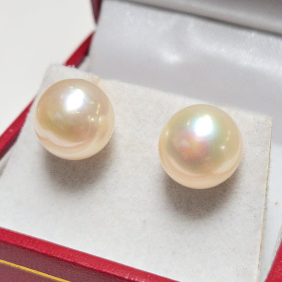 14K gold stud earrings with round pearls from Chique Jewelry, showcasing elegant jewelry design and lustrous pearl details.