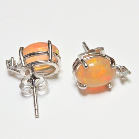 14K white gold stud earrings with 1.68ct oval opal gemstones from Chique Jewelry, showcasing elegant jewelry design.