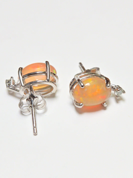 14K white gold stud earrings with 1.68ct oval opal gemstones from Chique Jewelry, showcasing elegant jewelry design.