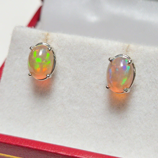 14K white gold stud earrings with 1.7ct oval opal gemstones from Chique Jewelry, showcasing elegant jewelry design.