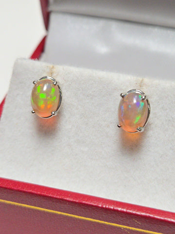 14K white gold stud earrings with 1.7ct oval opal gemstones from Chique Jewelry, showcasing elegant jewelry design.