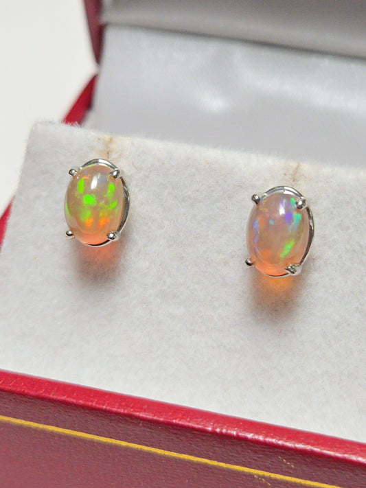 14K white gold stud earrings with 1.7ct oval opal gemstones from Chique Jewelry, showcasing elegant jewelry design.