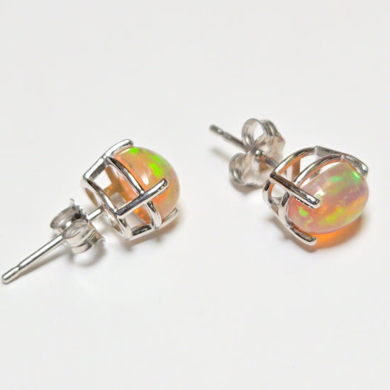 14K white gold stud earrings with 1.7ct oval opal gemstones, featuring a sleek and elegant jewelry design.