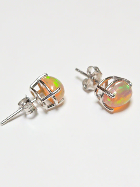14K white gold stud earrings with 1.7ct oval opal gemstones, featuring a sleek and elegant jewelry design.