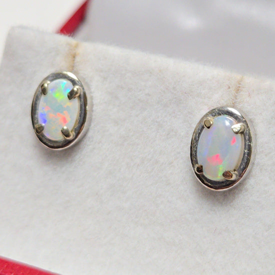 14K white gold stud earrings with oval opal gemstones, featuring elegant jewelry design by Chique Jewelry.