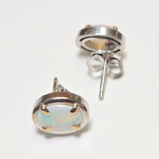 14K white gold oval opal stud earrings from Chique Jewelry, showcasing elegant gemstone settings and polished finish.