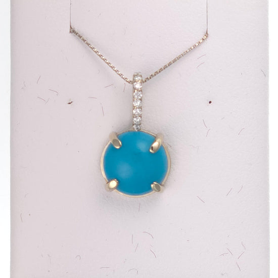 14k white gold pendant featuring a 2 ct round turquoise gemstone, displayed with a delicate chain.