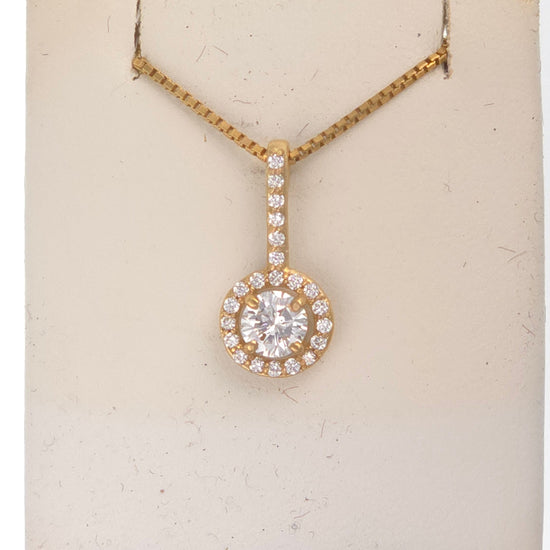 14k gold pendant with 0.5 ct round diamond GH-VS2 and 0.2 ct side diamonds G-VS1, featuring intricate design and sparkling gemstones.