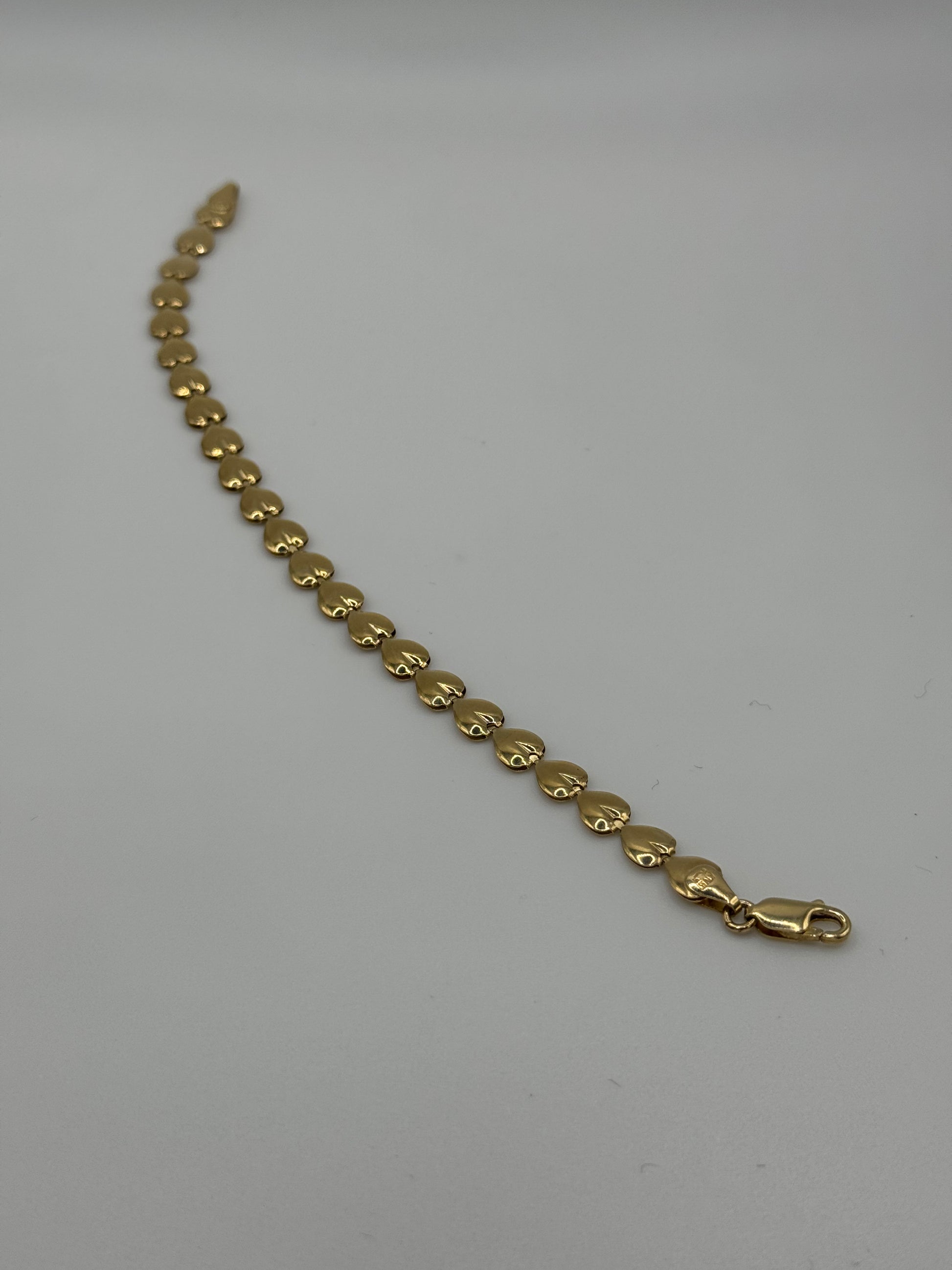 7-inch 14k gold link bracelet with 5.8mm width from Chique Jewelry, showcasing a polished chain design.