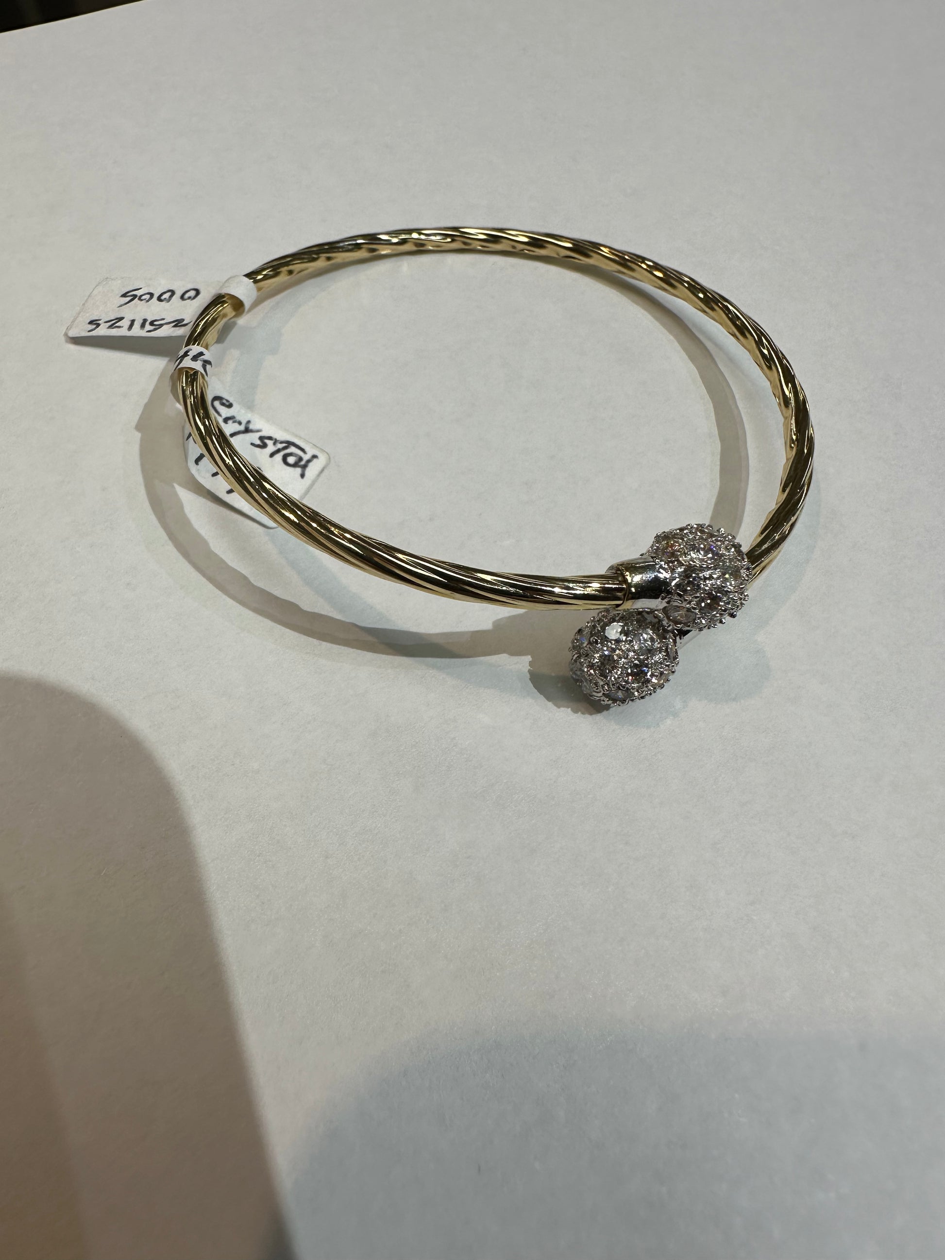 14k gold bangle bracelet with crystal accents from Chique Jewelry, showcasing a sleek, elegant design and polished finish.