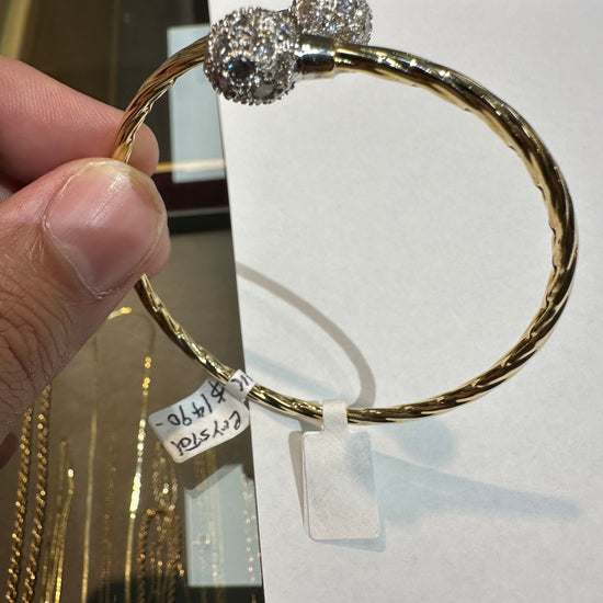 14k gold bangle bracelet with crystal accents from Chique Jewelry, featuring a sleek design and weighing 8.2 grams.