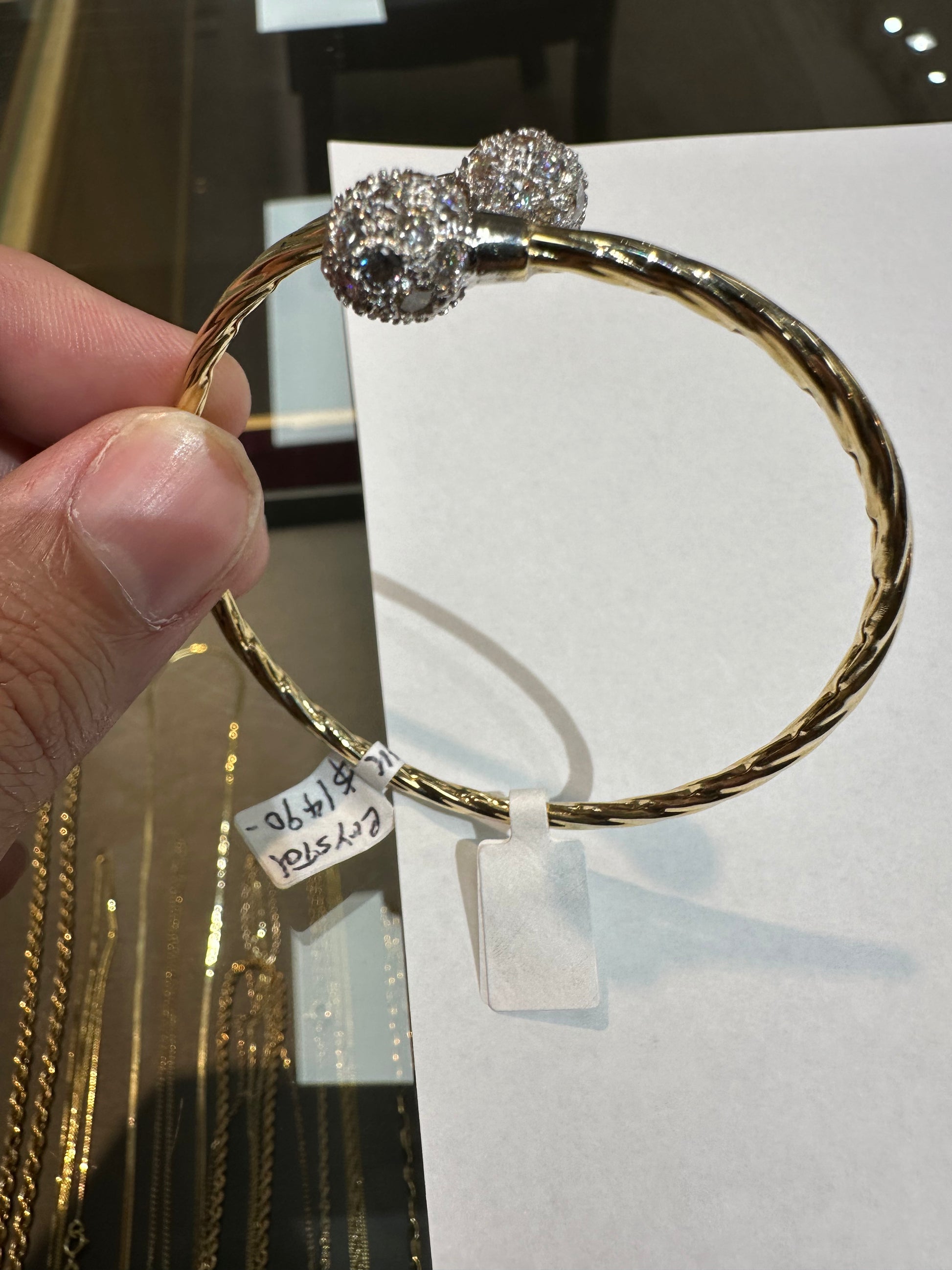 14k gold bangle bracelet with crystal accents from Chique Jewelry, featuring a sleek design and weighing 8.2 grams.