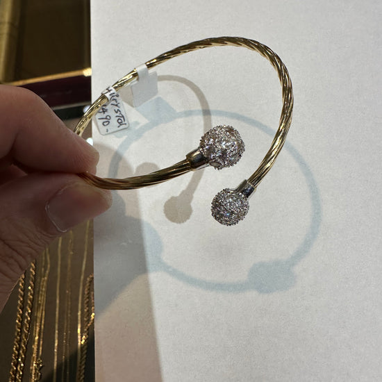 14k gold bangle bracelet with crystal accents from Chique Jewelry, showcasing an elegant and polished design.